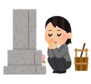 お墓参りをする女性。
