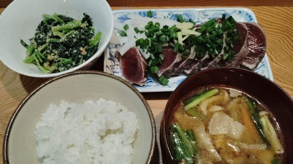 ごはん。かつおのたたき(大根スライス、ねぎ、しょうが)。ほうれん草の胡麻和え。みそ汁(豚肉、ゴボウ、人参、きのこ、わかめ、ねぎ)。