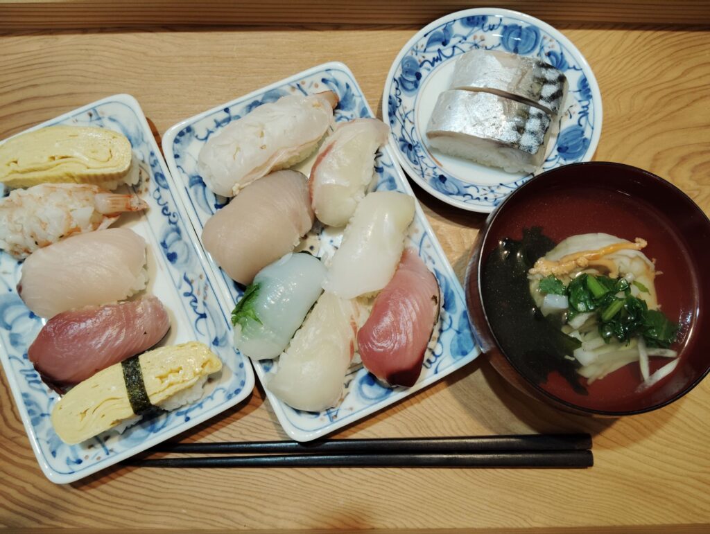 にぎりずし（鯛、さわら、かつお、えび、いか、たまご）。鯖寿司。すまし汁（えび、大根、大根葉、わかめ）。